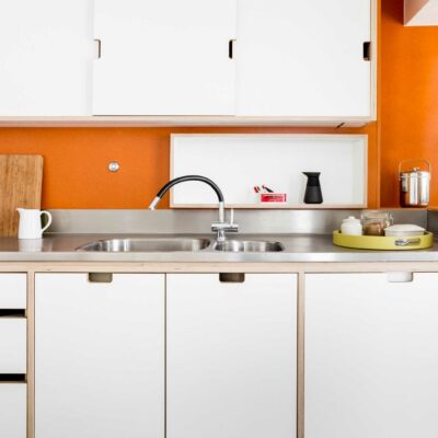 Modern minimal kitchen with orange Velchromat