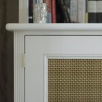 White bookcase with brass grille