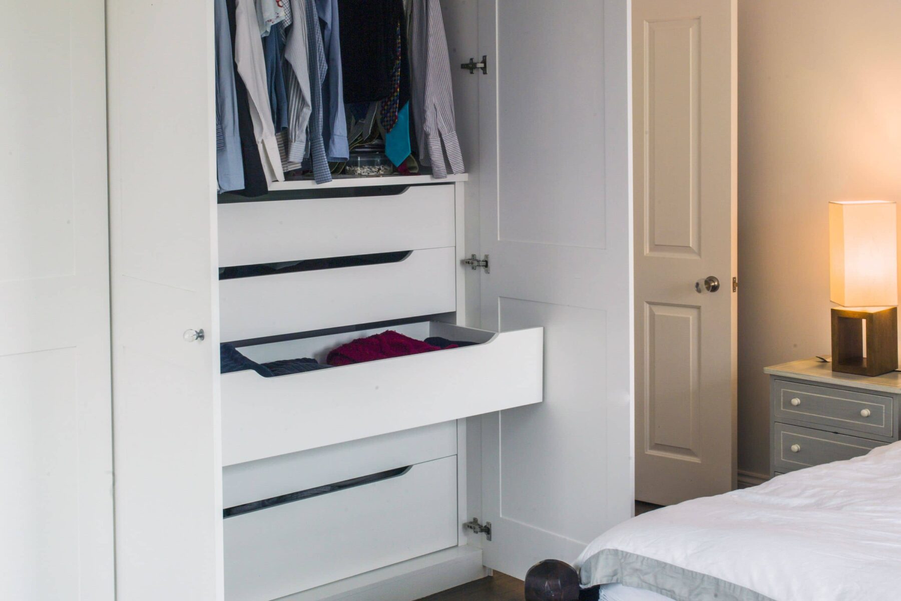 White fitted wardrobe with drawers in master bedroom