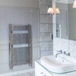 Marble tiled bathroom designed by Mia Marquez
