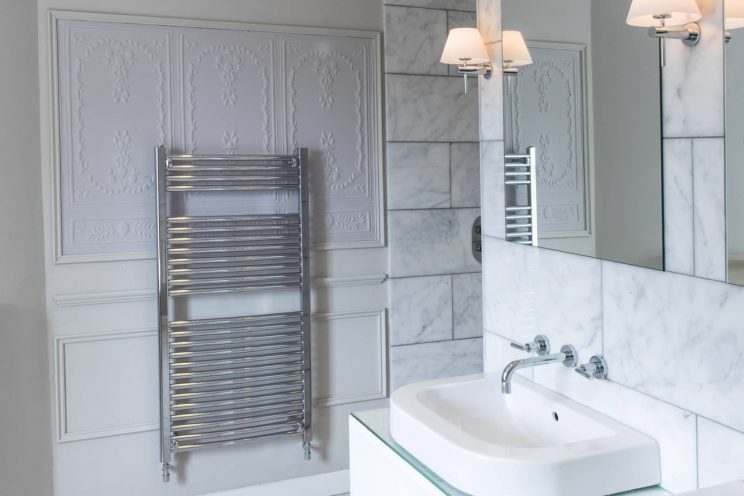 Marble tiled bathroom designed by Mia Marquez