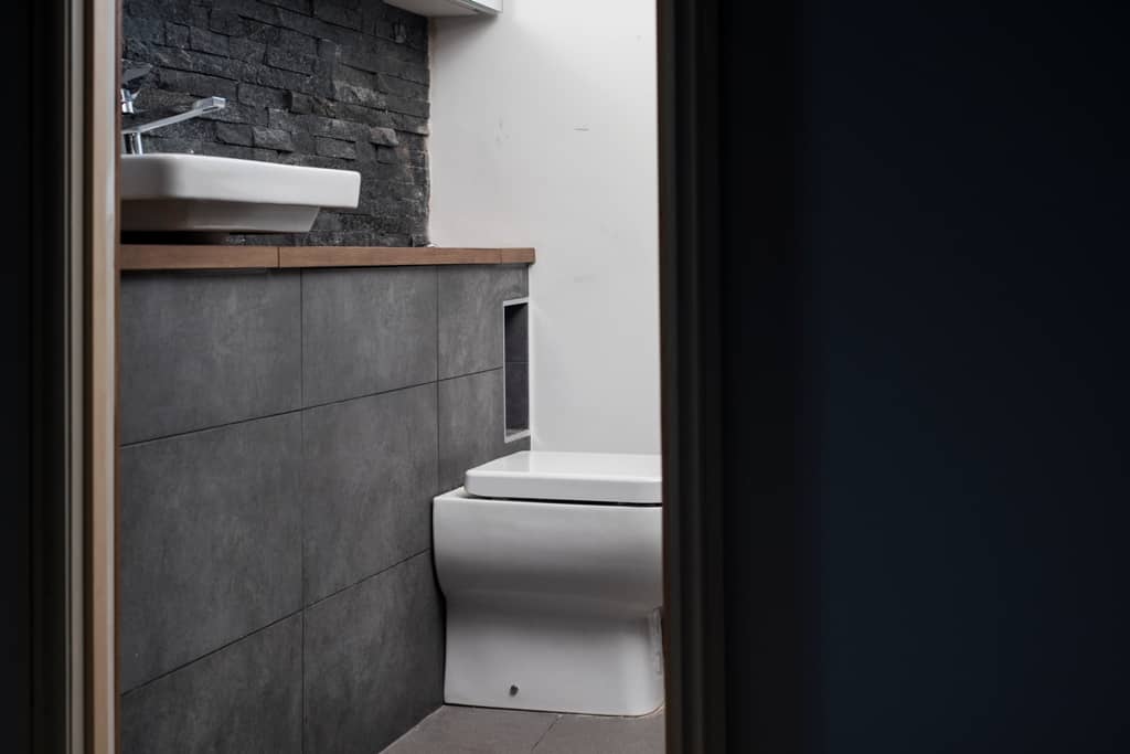 Modern slate tiled bathroom with ceramic white sink