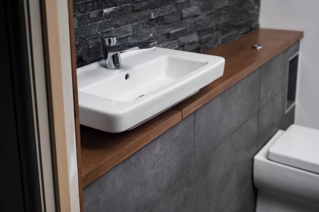 Slate tiled bathroom with ceramic white sink