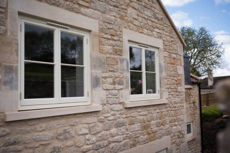 French style casement windows in modern stone house near Bath