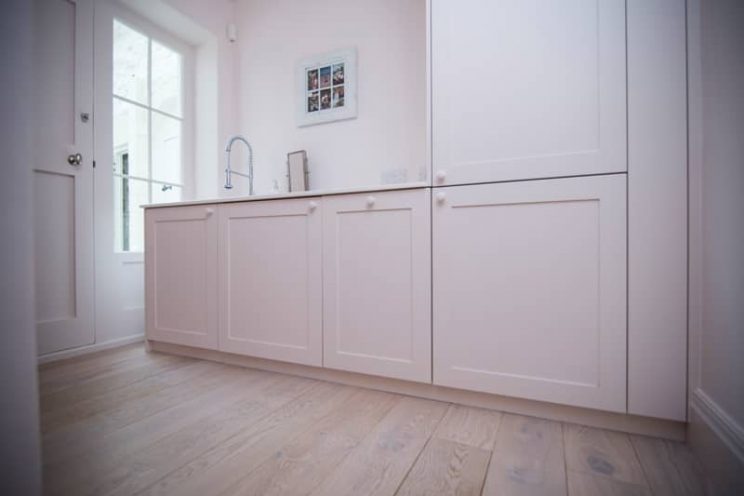 pink bathroom cabinets with wooden flooring