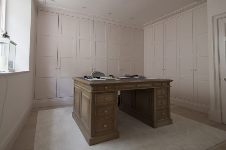 Large fitted pink wardrobes in study