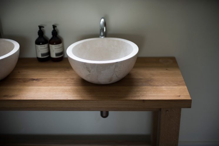 Marble sink basin and oak bathroom vanity unit