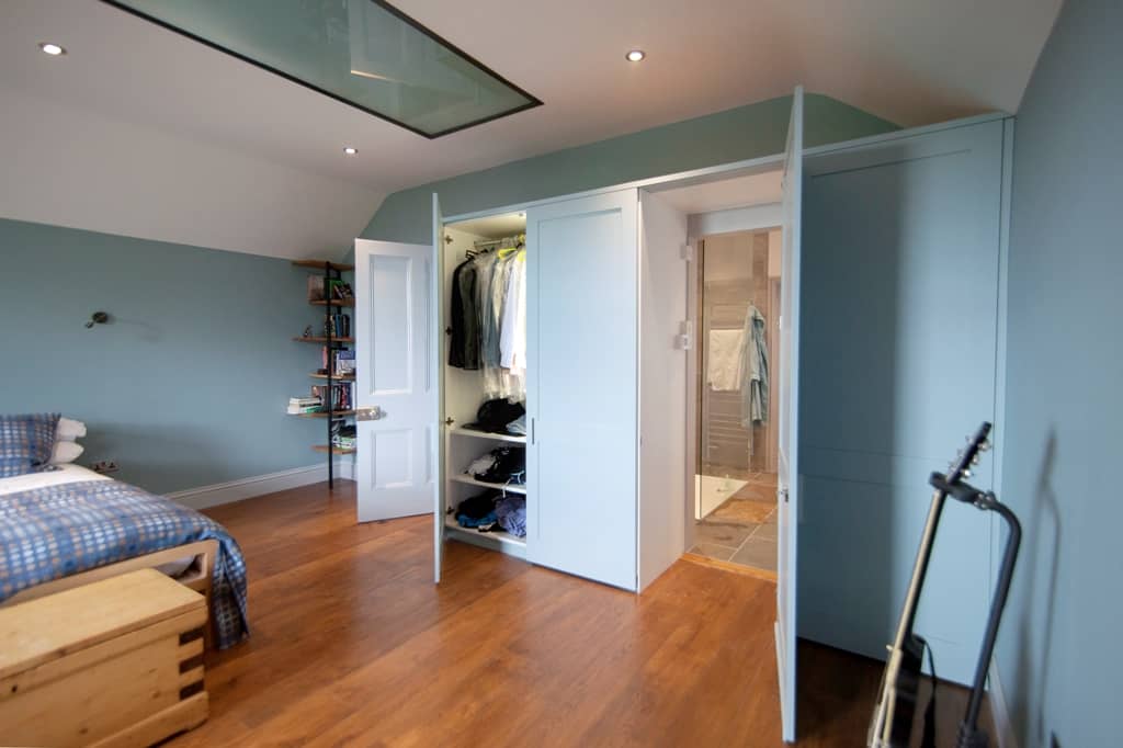 Fitted wooden wardrobe in bedroom