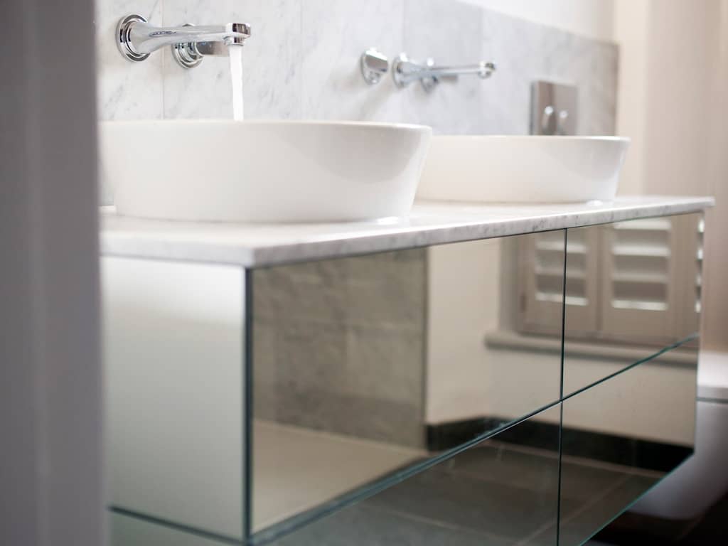 Modern mirrored sink unit with ceramic white sinks