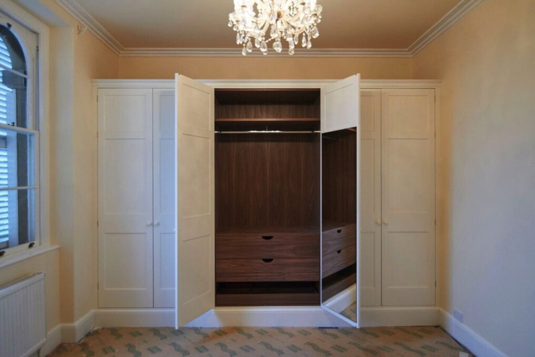 Traditional fitted wardrobe in bedroom