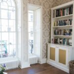 Custom-made white cabinets with bookshelves