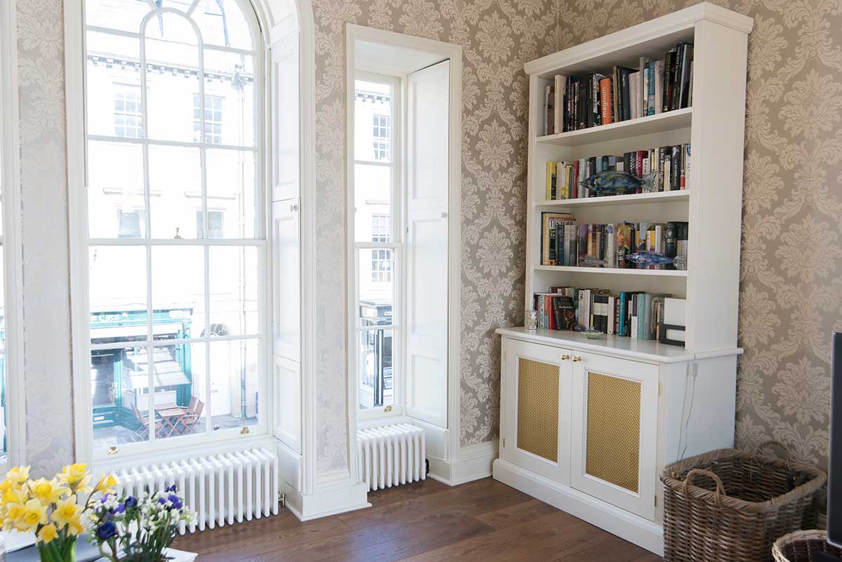 Custom-made white cabinets with bookshelves
