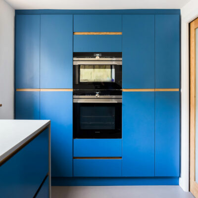 Electric blue modern kitchen large larder with double tier cooker