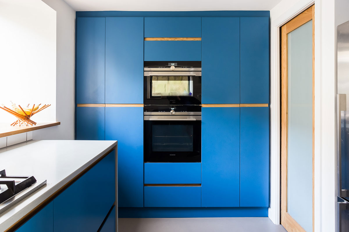 Electric blue modern kitchen large larder with double tier cooker