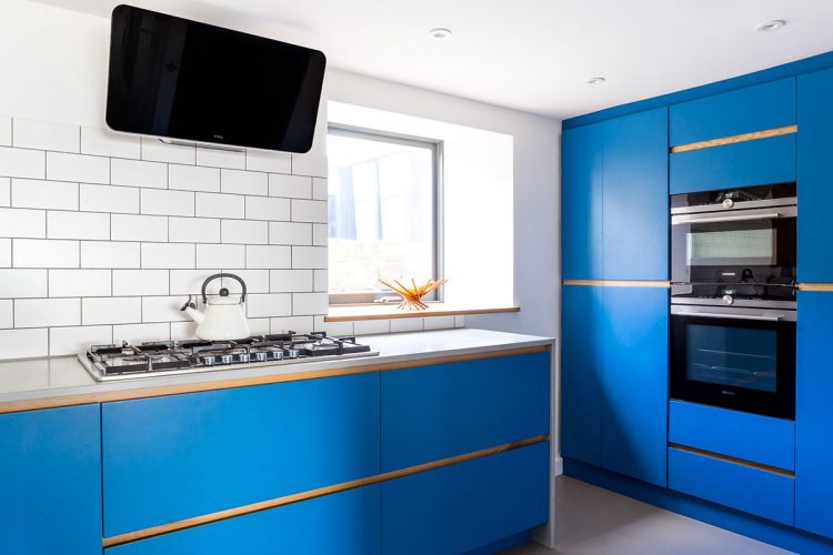 Electric blue modern kitchen with traditional hob cream kettle