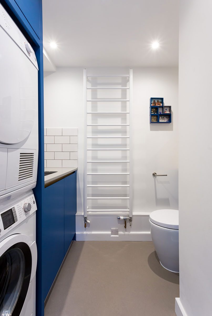 Double tier washing machine and dryer in galley shaped utility room
