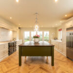 Traditional kitchen with a walnut island finished in Invisible Greene