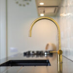 Classic kitchen with brushed gold tap