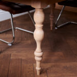 Oval table with custom designed turned legs
