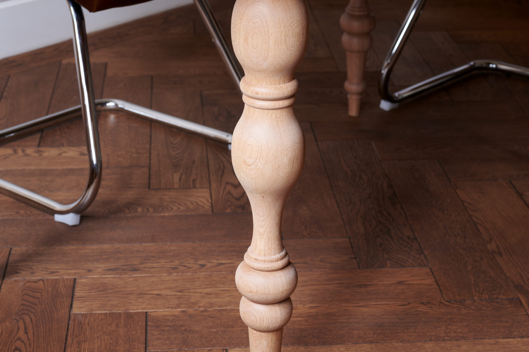 Oval table with custom designed turned legs