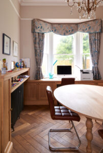 Home office with fitted desk and custom made oval table